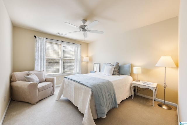 bedroom featuring ceiling fan, baseboards, visible vents, and light carpet