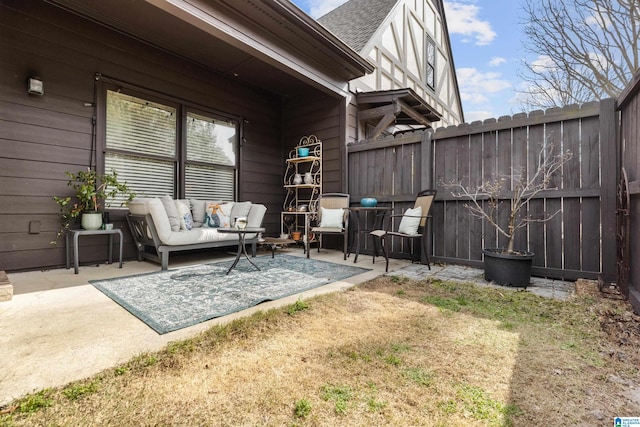 view of patio with outdoor lounge area and fence