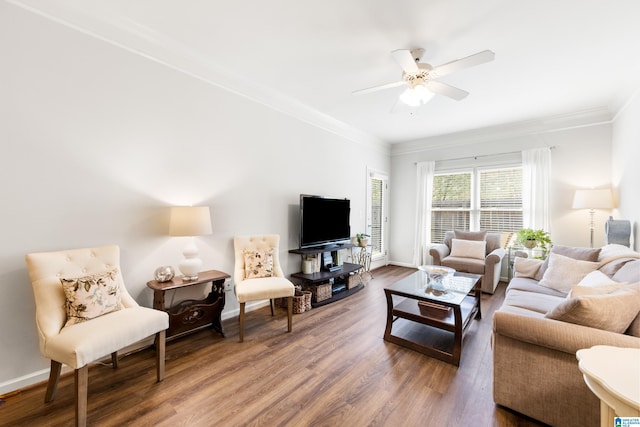 living room featuring ornamental molding, baseboards, a ceiling fan, and wood finished floors