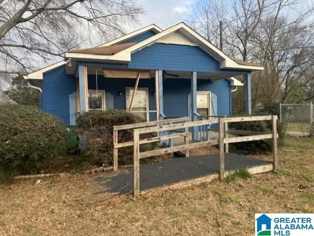 bungalow-style house featuring a porch and fence