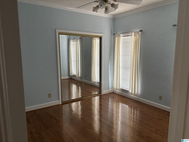 unfurnished room with wood finished floors, a ceiling fan, and ornamental molding