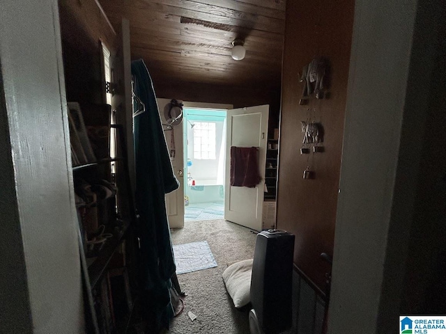 hallway featuring wood ceiling and carpet floors