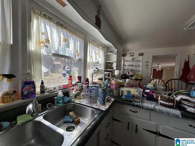 kitchen with white cabinetry and a sink