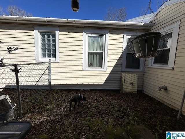 view of side of property featuring fence