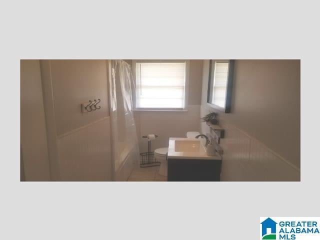 bathroom with vanity, toilet, and tile patterned flooring