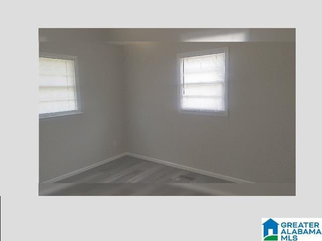 unfurnished room featuring baseboards