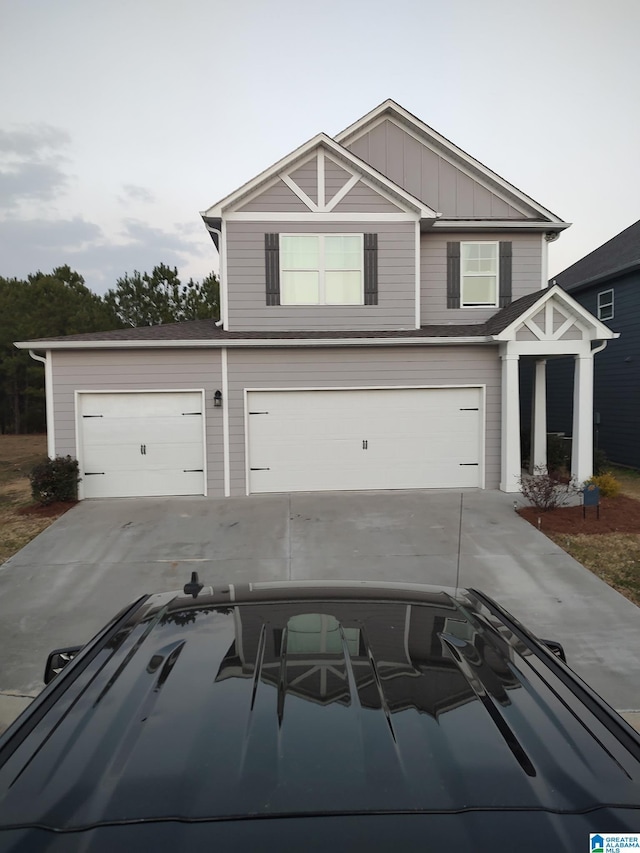 view of front of property with concrete driveway and board and batten siding