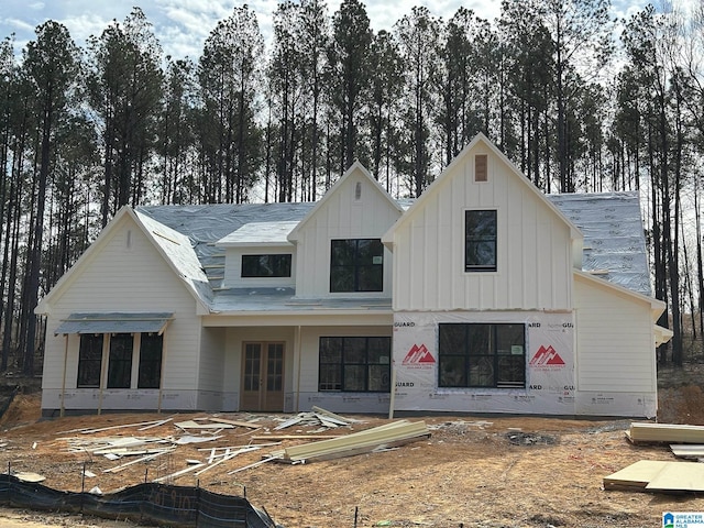 view of front facade with french doors and board and batten siding