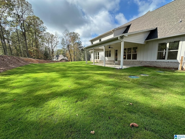 view of yard with a patio area and ceiling fan