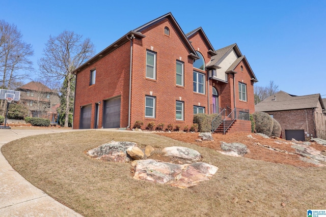 view of front of property with brick siding, driveway, and a garage