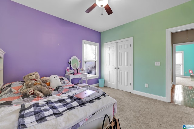 bedroom with baseboards, carpet, attic access, a closet, and a ceiling fan