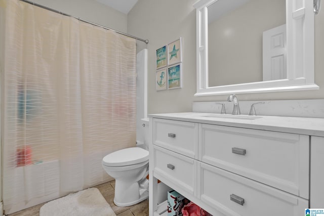 full bath with tile patterned floors, toilet, shower / tub combo with curtain, and vanity