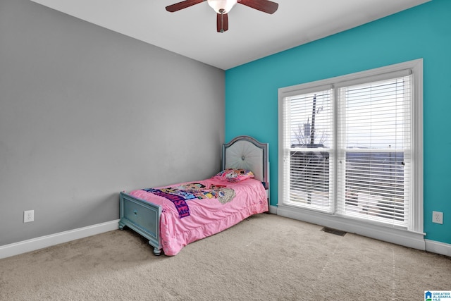 bedroom featuring a ceiling fan, carpet flooring, baseboards, and visible vents