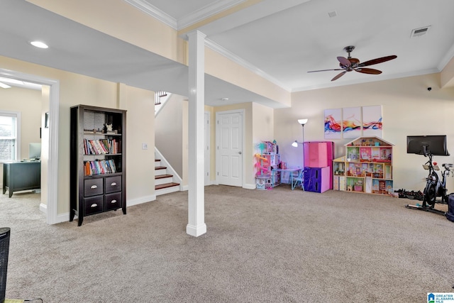 rec room with a ceiling fan, visible vents, baseboards, crown molding, and carpet flooring