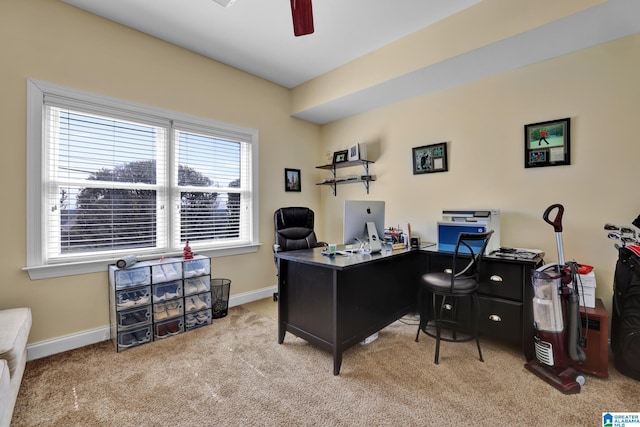 carpeted home office featuring a ceiling fan and baseboards