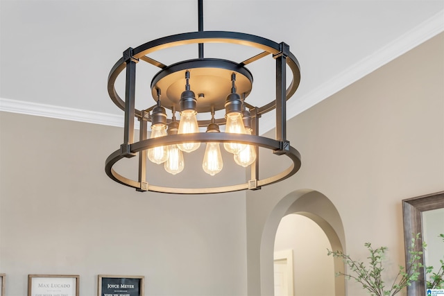 room details featuring arched walkways, an inviting chandelier, and ornamental molding