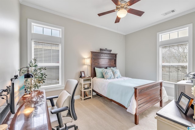 bedroom with visible vents, light colored carpet, multiple windows, and ornamental molding