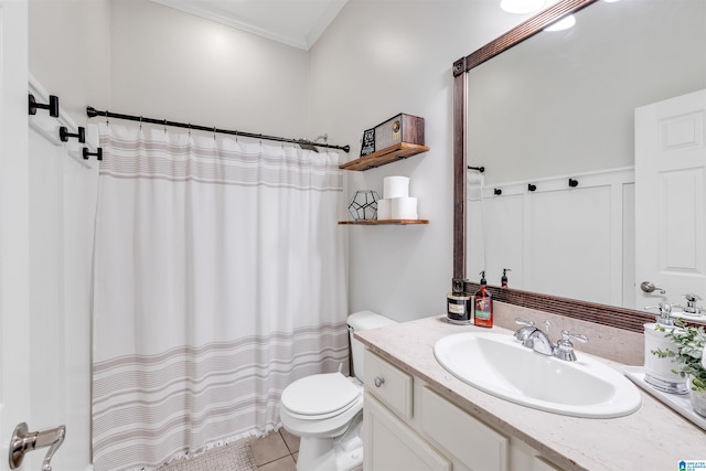 full bathroom featuring tile patterned floors, crown molding, toilet, and vanity