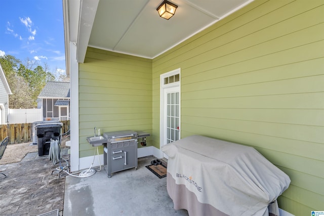 view of patio / terrace featuring grilling area and fence