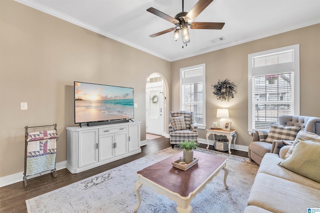 living room with visible vents, baseboards, ceiling fan, ornamental molding, and dark wood-style flooring