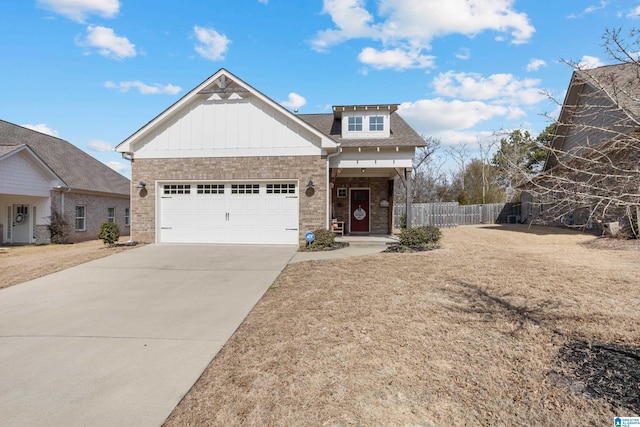 view of front of home with brick siding, an attached garage, board and batten siding, fence, and driveway