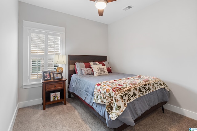 carpeted bedroom with visible vents, ceiling fan, and baseboards