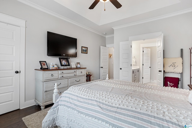 bedroom with dark wood-type flooring, ornamental molding, a tray ceiling, baseboards, and ceiling fan