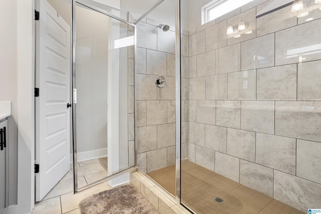 full bath featuring tile patterned flooring and a stall shower