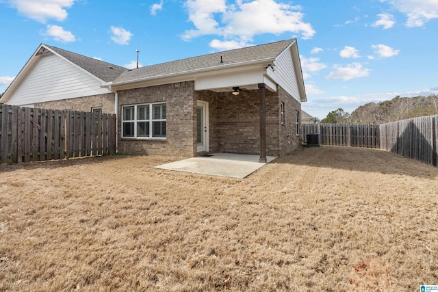 back of property featuring brick siding, ceiling fan, central air condition unit, a fenced backyard, and a patio