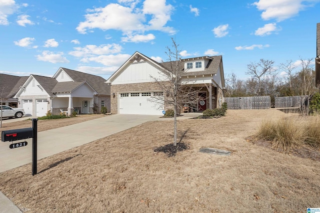 view of front facade with a garage, driveway, and fence