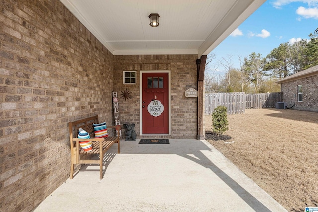 entrance to property with central AC and fence