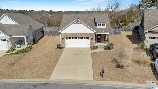 view of front of property with fence, a shingled roof, concrete driveway, a garage, and board and batten siding