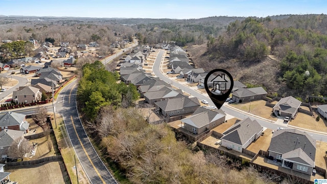 drone / aerial view with a forest view and a residential view