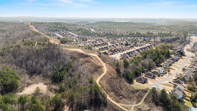 drone / aerial view featuring a forest view and a residential view