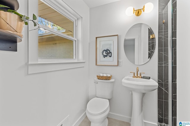 bathroom with baseboards and toilet