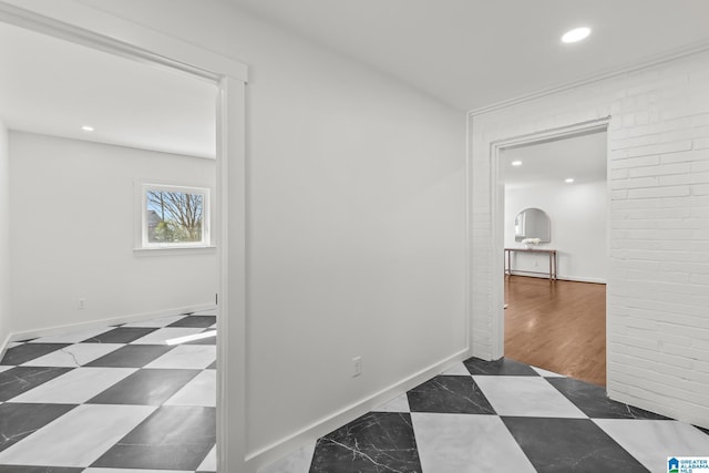 hall with recessed lighting and baseboards