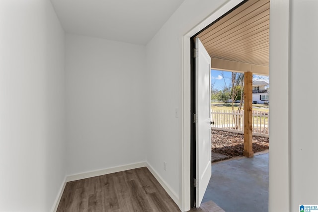 entryway featuring baseboards and wood finished floors