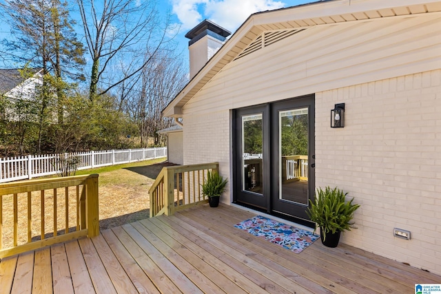 wooden terrace featuring fence and a lawn