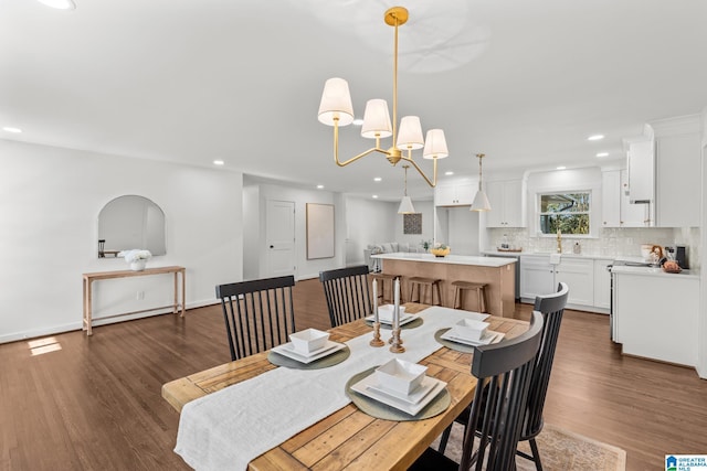 dining space with dark wood-type flooring, recessed lighting, and baseboards