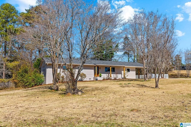 ranch-style house with a front yard and fence