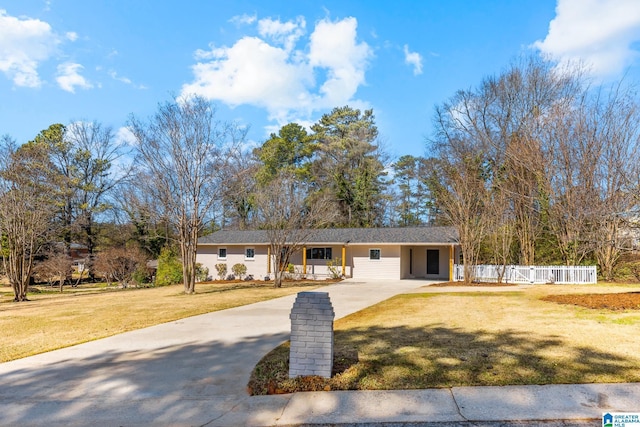 single story home featuring a front yard, concrete driveway, fence, and stucco siding