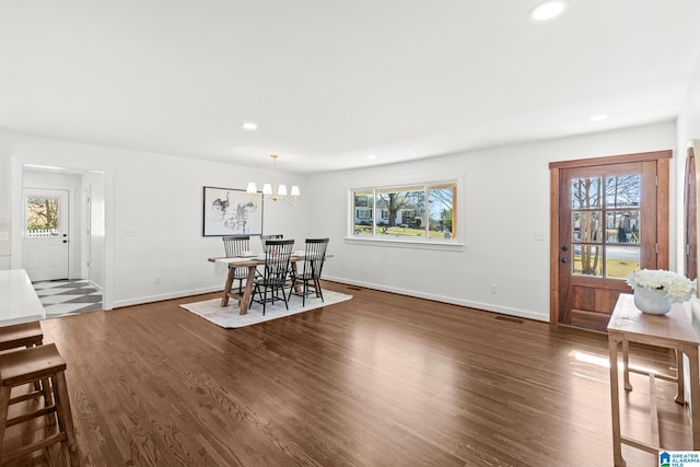 dining area featuring a wealth of natural light, dark wood-type flooring, and recessed lighting