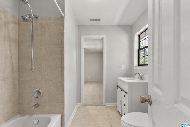 bathroom featuring visible vents, baseboards, washtub / shower combination, tile patterned floors, and vanity