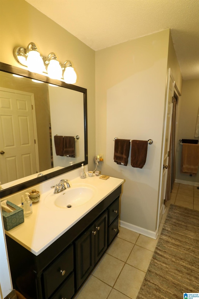 full bath featuring tile patterned floors, vanity, and baseboards