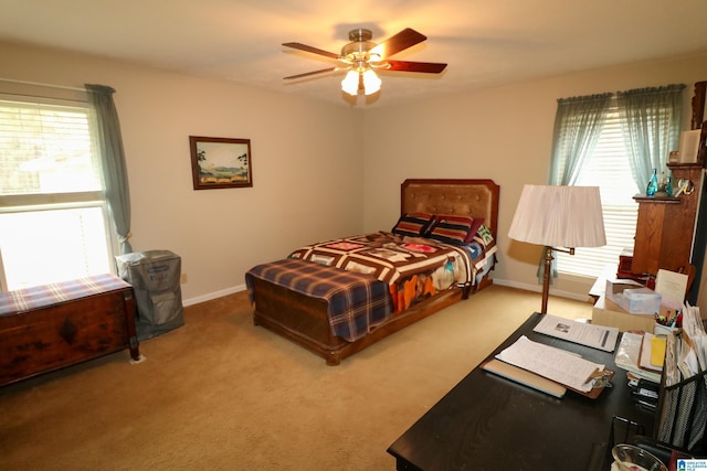 carpeted bedroom with a ceiling fan and baseboards