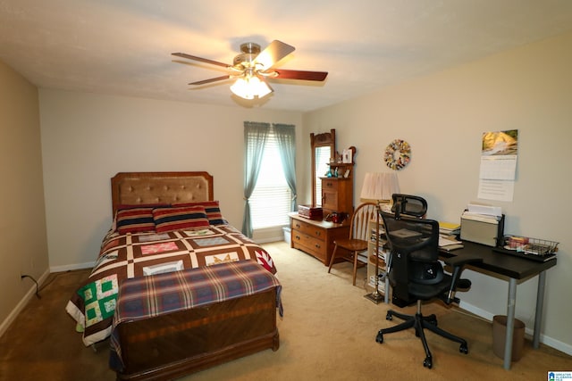 carpeted bedroom with a ceiling fan and baseboards