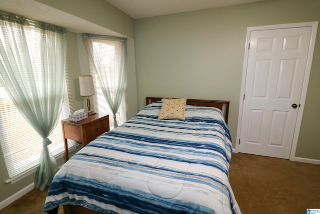 carpeted bedroom featuring baseboards