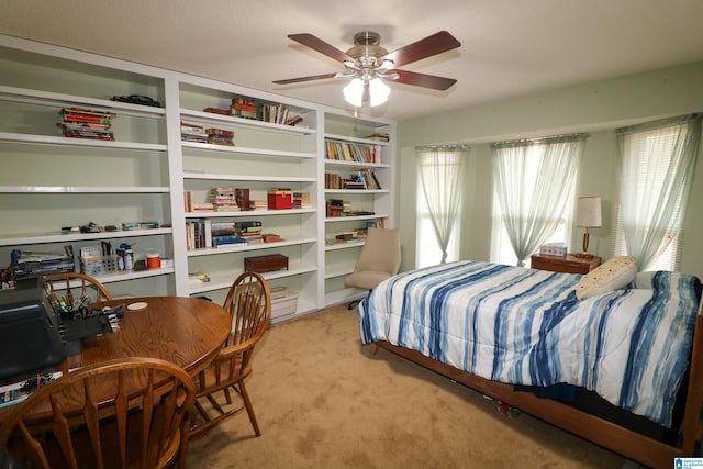 bedroom with multiple windows, light carpet, and a ceiling fan