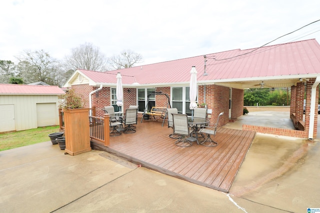 wooden deck with outdoor dining area and an outdoor structure