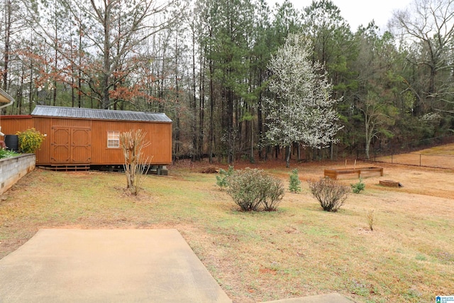 view of yard featuring an outbuilding and a patio